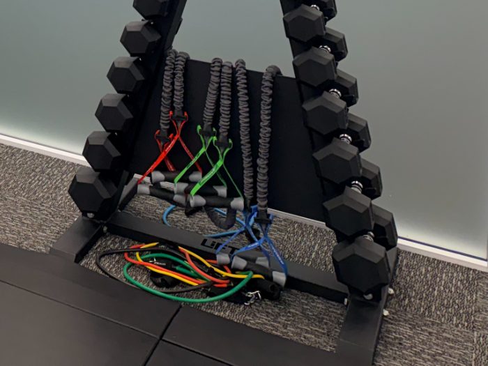 A-frame rack of light dumbbells with resistance bands and handles